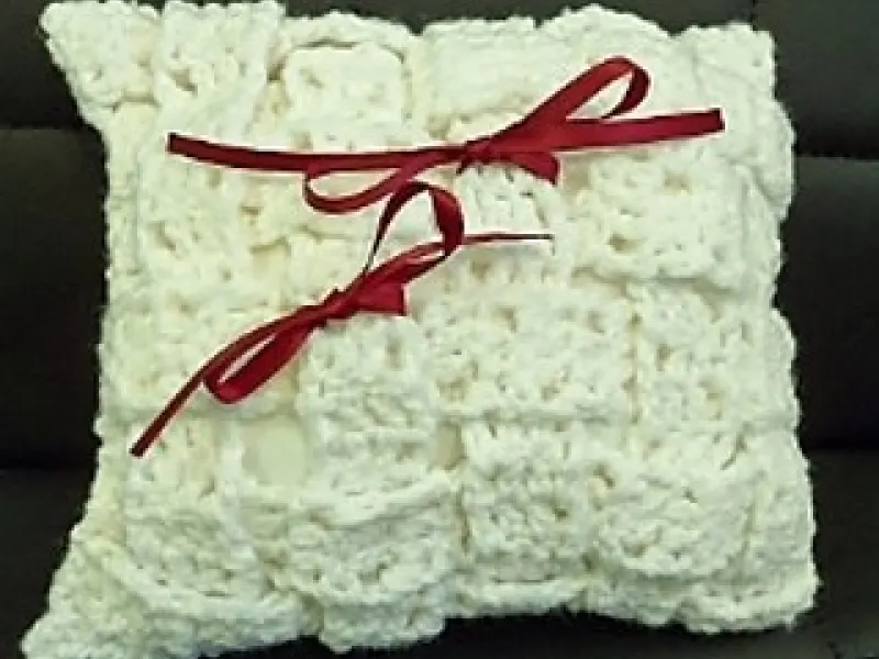 Cream crochet ring bearer pillow with ribbon and rings