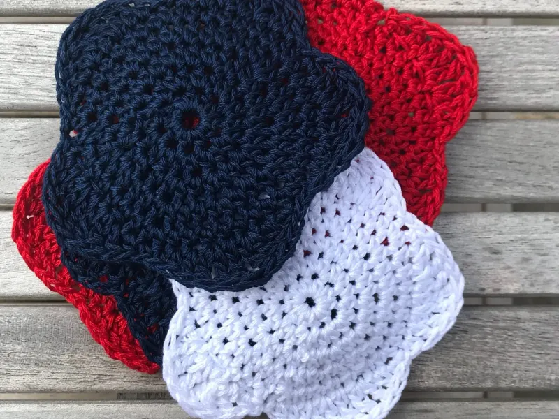 Set of star-shaped crochet coasters in red, white and blue
