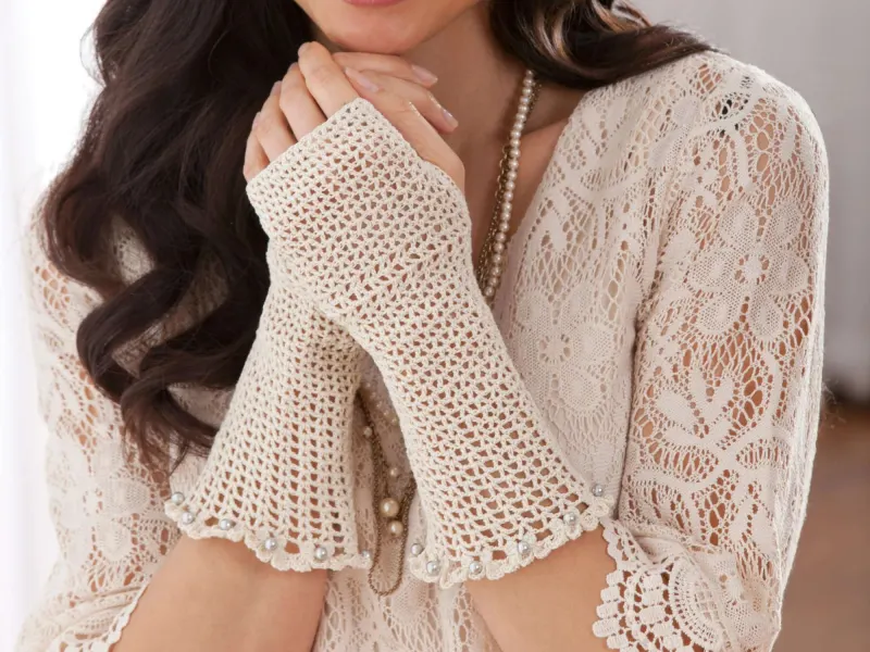 Pair of white lace crochet armlets on forearms