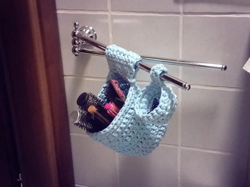 Set of small chunky crochet baskets hanging from hooks