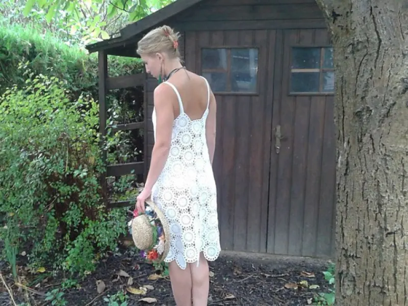 White thread crochet summer dress against a bright background