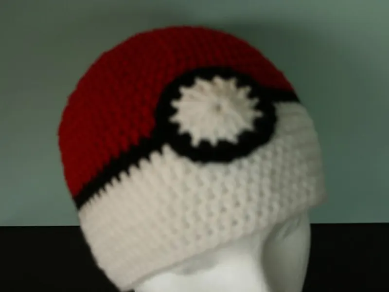 Fitted crochet Poke Ball hat with black stripe and button