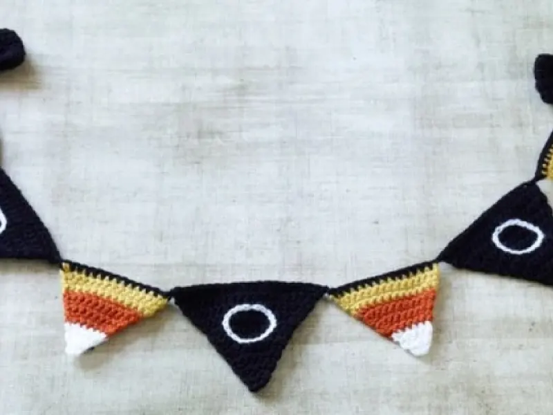 Colorful crochet Halloween pennants hanging on a line